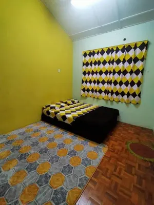 a room with a bed and a window in it at RS Homestay Gerik in Gerik