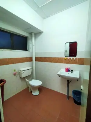 a bathroom with a toilet and a sink at RS Homestay Gerik in Gerik