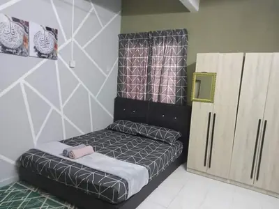 a small bedroom with a bed and a cabinet at RS Homestay Gerik in Gerik