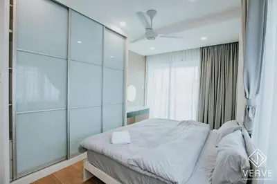 a bedroom with a bed and a glass wall at Ipoh Mansion House 25 by Verve in Ipoh