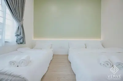 two white beds in a room with a window at Ipoh Mansion House 25 by Verve in Ipoh