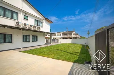 a backyard with a lawn in front of a house at Ipoh Mansion House 25 by Verve in Ipoh