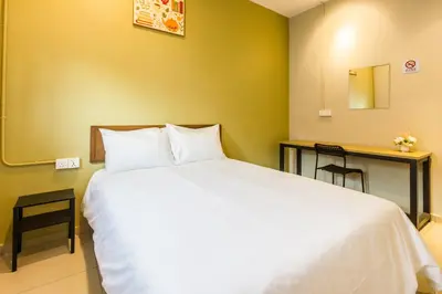a bedroom with a large white bed and a desk at Urban 10pax Terrace Gem near Sunway Carnival in Perai
