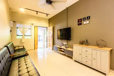 a living room with a couch and a flat screen tv at Urban 10pax Terrace Gem near Sunway Carnival in Perai