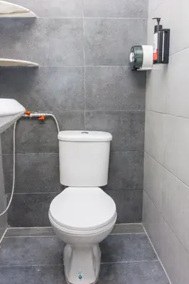 a bathroom with a white toilet and a sink at Urban 10pax Terrace Gem near Sunway Carnival in Perai