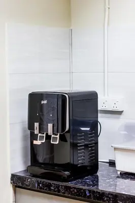 a black coffee maker on a counter in a kitchen at Urban 10pax Terrace Gem near Sunway Carnival in Perai
