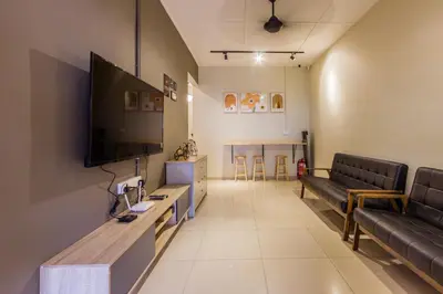 a living room with couches and a flat screen tv at Urban 10pax Terrace Gem near Sunway Carnival in Perai
