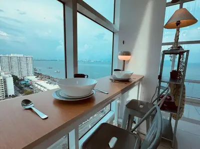 a room with a counter with a view of the ocean at NEW - Panorama Komtar SeaView Meritime Suites in Jelutong