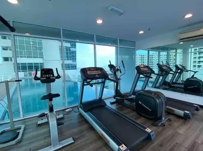 a gym with several treadmills in a building at NEW - Panorama Komtar SeaView Meritime Suites in Jelutong