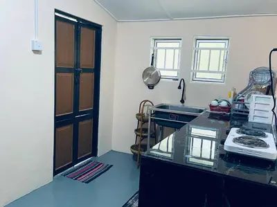 a kitchen with a counter with a sink and a stove at Inap Desa R'Sawit Pintu B in Sekincan