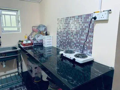 a kitchen with a counter top with a appliance on it at Inap Desa R'Sawit Pintu B in Sekincan