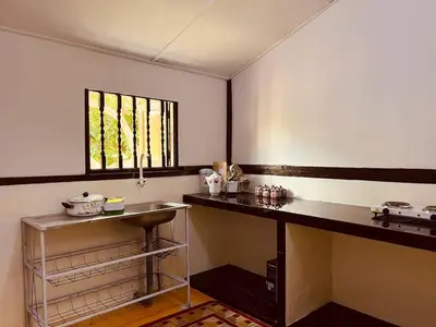 a kitchen with a counter and a window at Inap Desa R'Sawit - A dan B in Sekincan