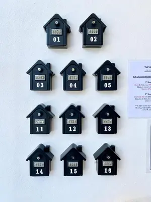a bunch of clocks hanging on a wall at The 6N by Sky Hive in George Town