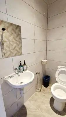 a bathroom with a sink and a toilet at The 6N by Sky Hive in George Town