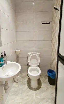 a bathroom with a toilet and a sink at The 6N by Sky Hive in George Town