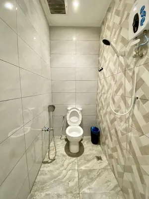 a bathroom with a toilet and a shower at The 6N by Sky Hive in George Town