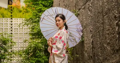 a woman in a kimono holding an umbrella at Zen By Stellar Cameron in Brinchang