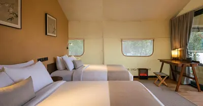 a bedroom with two beds and a desk and two windows at Zen By Stellar Cameron in Brinchang