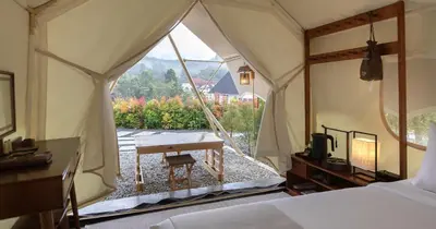 a bedroom with a tent with a table and a view at Zen By Stellar Cameron in Brinchang
