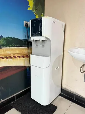 a white refrigerator in a bathroom next to a sink at Hotel Pinji Ipoh in Ipoh