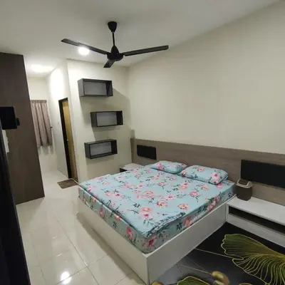 a bedroom with a bed and a ceiling fan at Mimms Homestay Teluk Intan in Teluk Intan