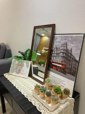a table with potted plants and a picture of a building at TeaValleyView & FarmView - 3BR Cool Summer Cameron in Cameron Highlands