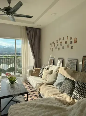a living room with a couch and a large window at TeaValleyView & FarmView - 3BR Cool Summer Cameron in Cameron Highlands