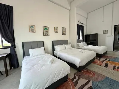 a bedroom with two beds with white sheets at Ferringhi Inn 51 in Batu Ferringhi