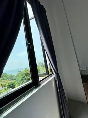 a window with black curtains in a room at Ferringhi Inn 51 in Batu Ferringhi