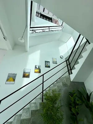 a staircase in a house with a glass railing at Ferringhi Inn 51 in Batu Ferringhi