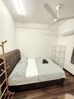 a bedroom with a bed and a ceiling fan at Tur16 SPlCE 10pax 4room Private House in Bayan Lepas