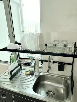 a kitchen with a sink and a shelf with dishes at Tur16 SPlCE 10pax 4room Private House in Bayan Lepas
