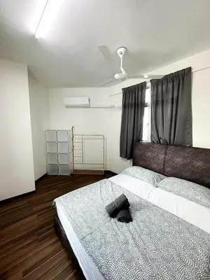 a bedroom with a bed with a hat on it at Tur16 SPlCE 10pax 4room Private House in Bayan Lepas