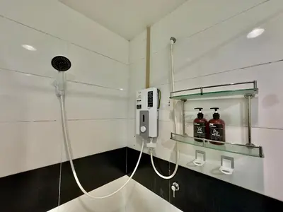 a bathroom with a phone and bottles of alcohol at Mansion One at Gurney Drive Georgetown by 3C in George Town