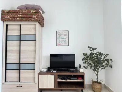 a living room with a tv and a bed on a shelf at Mansion One at Gurney Drive Georgetown by 3C in George Town