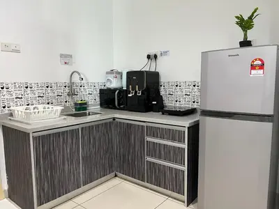 a kitchen with a refrigerator and a counter at Mansion One at Gurney Drive Georgetown by 3C in George Town