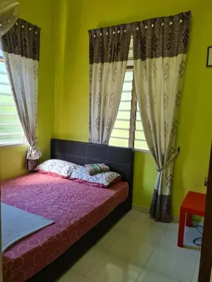 a bedroom with a bed in a room with windows at de'berah homestay penaga in Penaga