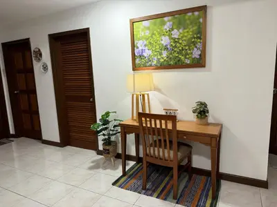 a desk with a chair and a painting on the wall at Sevenseas Family Home Copthorne Cameron Highland in Brinchang
