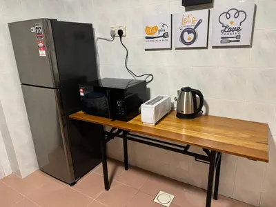 a table with a coffee maker and a refrigerator at Sevenseas Family Home Copthorne Cameron Highland in Brinchang