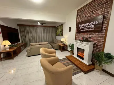 a living room with a couch and a fireplace at Sevenseas Family Home Copthorne Cameron Highland in Brinchang