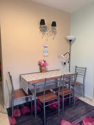 a dining room with a table and chairs at Homestay Permai Lake View in Kampong Batu Lapan