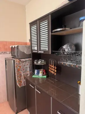 a kitchen with a stainless steel refrigerator in a kitchen at Homestay Permai Lake View in Kampong Batu Lapan