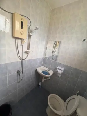 a bathroom with a toilet and a sink at Homestay Permai Lake View in Kampong Batu Lapan