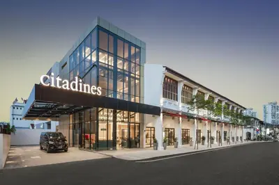 a building with a car parked in front of it at Citadines Connect Cecil Georgetown Penang in George Town