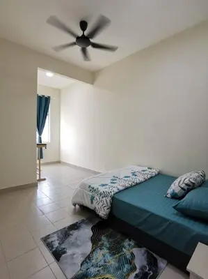 a bedroom with a bed with a ceiling fan at 4-Bedroom Homestay in Taiping, Perak in Kamunting