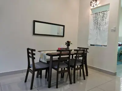 a dining room table with chairs and a mirror at 4-Bedroom Homestay in Taiping, Perak in Kamunting