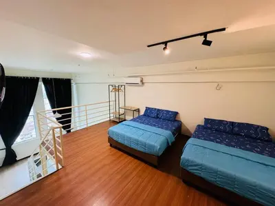 a bedroom with two beds and a balcony at The CEO Suits in Bayan Lepas