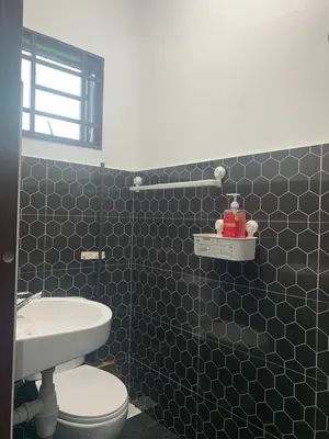 a bathroom with a white toilet and a sink at HOMeSTAY DAMIA - Islam Homestay Only in Teluk Intan