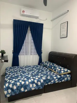 a bedroom with a bed with blue curtains and a window at HOMeSTAY DAMIA - Islam Homestay Only in Teluk Intan