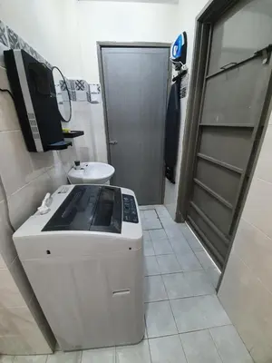 a kitchen with a stove and a sink and a door at Teratak Ayuni with Private pool in Batu Gajah